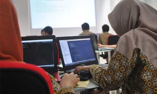 Students learning computer science in classroom